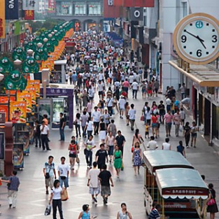 shoppers walking along pedestrianised street, chengdu